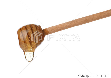 Honey dripping from wooden dipper isolated on white 98761848