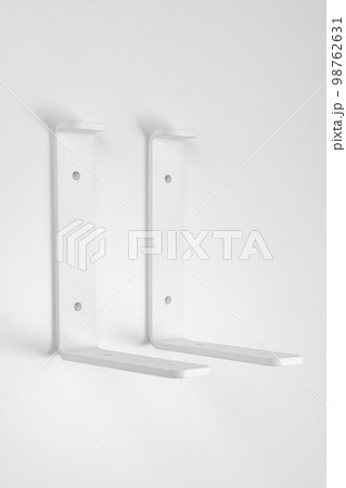 Bracket on a white background. support part for mounting shelves. Bracket on a white background. support part for mounting shelves. 98762631
