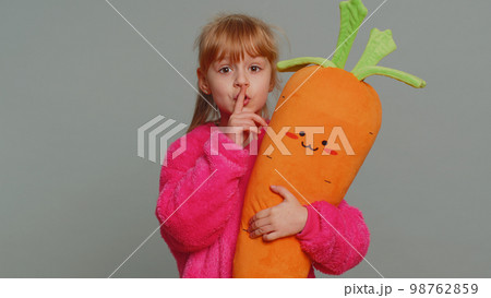 Preteen child girl presses finger to lips makes silence hush sign do not tells gossip secret, quiet Preteen child girl presses finger to lips makes silence hush sign do not tells gossip secret, quiet 98762859