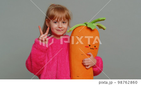 Young preteen child girl kid showing victory sign, hoping for success and win, doing peace gesture Young preteen child girl kid showing victory sign, hoping for success and win, doing peace gesture 98762860