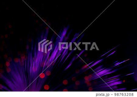 Luminous optical fiber. Fantastic backdrop of illuminated neon fiber optic lines and glowing red bokeh on black. Light guides create circles and light points in the dark. Abstract futuristic concept. 98763208