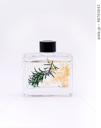Wooden aroma sticks in a glass flask filled with flavor liquid substance isolated over white background, side view Wooden aroma sticks in a glass flask filled with flavor liquid substance isolated over white background, side view 98763642