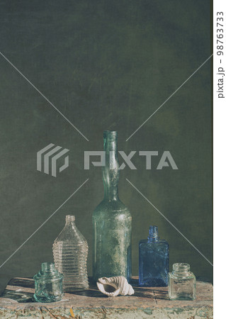 Still life with glass bottles of various shapes. art photography 98763733