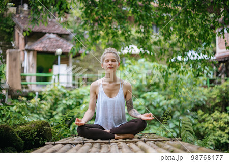 Girl practice yoga meditation outdoor in park 98768477