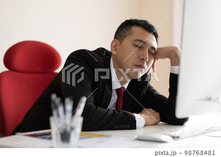 オフィスで眠くなる・疲れたビジネスマン 98768481
