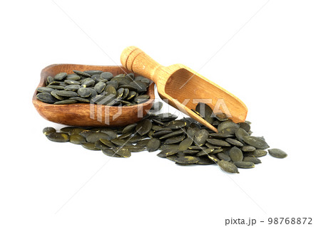 Raw pumpkin seeds or pepitas shelled in wooden scoop Raw pumpkin seeds or pepitas shelled in wooden scoop 98768872