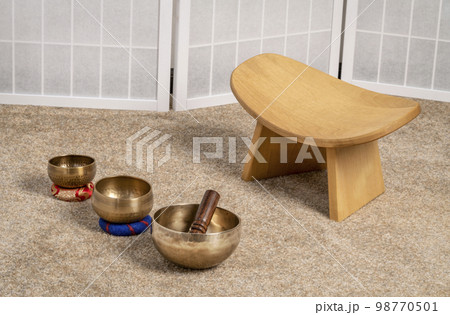 Tibetan singing bowls and meditation, kneeling bench to sit in a natural, balanced and relaxed posture 98770501