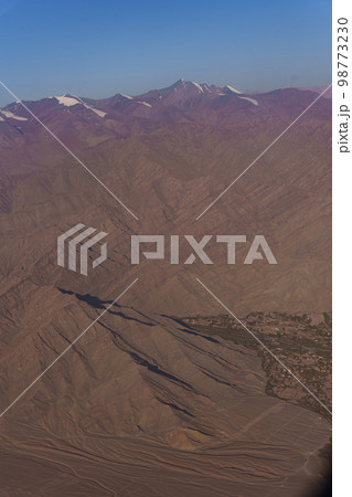 View from the plane to the surface of the earth with a mountain landscape of the Himalayas at Ladakh, India 98773230