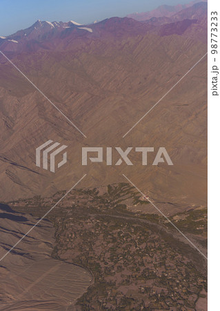 View from the plane to the surface of the earth with a mountain landscape of the Himalayas at Ladakh, India 98773233