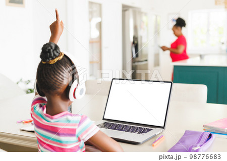 Rear view of african american girl raising hand...の写真素材 [98776683] - PIXTA