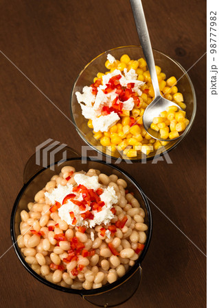 Esquites with corn and white kidney beans, cheese, mayonnaise and chili. Mexican street food. Top view 98777982