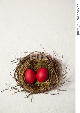 red eggs in the bird's nest on a white background red eggs in the bird's nest on a white background 98778577