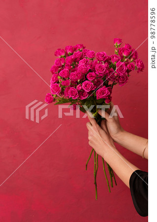Beautiful bouquet of pink roses in female hands Beautiful bouquet of pink roses in female hands 98778596