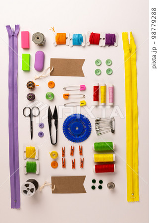 Image of sewing materials with scissors, buttons and threads on cream background 98779288