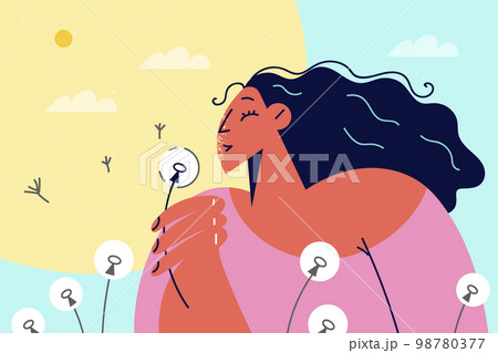 Smiling girl blow dandelion during summertime Smiling girl blow dandelion during summertime 98780377