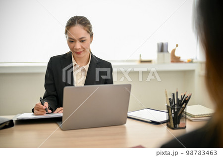 Female HR recruiter interviewing a candidate in the meeting room. job recruitment Female HR recruiter interviewing a candidate in the meeting room. job recruitment 98783463