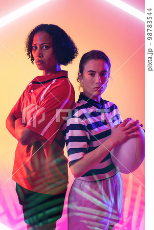 Illuminated lines and plants over multiracial confident female opponents standing back to back Illuminated lines and plants over multiracial confident female opponents standing back to back 98783544