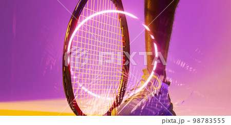 Illuminated circle and plants over cropped leg of african american male tennis player with racket 98783555