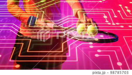 Midsection of biracial female tennis player holding balls and racket over connected dots 98785703