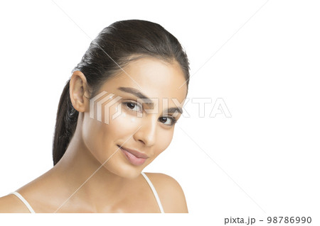 Portrait of smiling young woman looking at camera Portrait of smiling young woman looking at camera 98786990