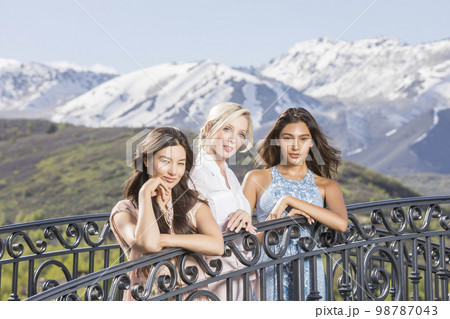 USA, Utah, Midway, Portrait of beautiful women on footbridge in mountain scenery 98787043