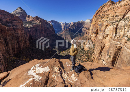 USA, Utah, Zion National Park, Senior female hiker at overlook of Zion National Park 98787312