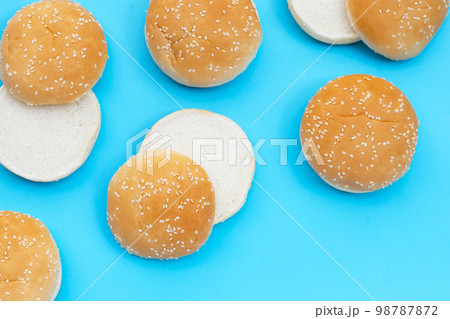 Hamburger buns with sesame on blue background. Hamburger buns with sesame on blue background. 98787872