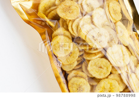 Banana slice chips in package bag on white background. 98788998