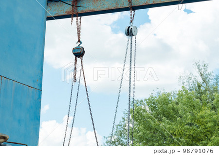 old iron structure with hook chains on the street old iron structure with hook chains on the street 98791076