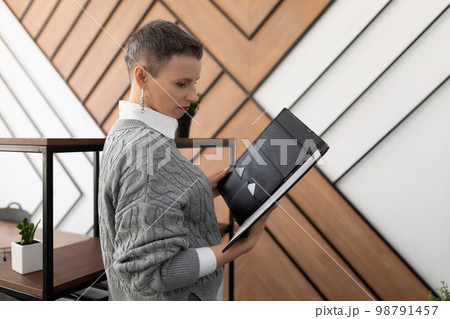 woman businessman examines documents leather folders in the office woman businessman examines documents leather folders in the office 98791457