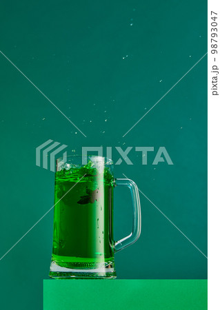 Extraordinary taste. Mug with green beer and anis isolated over green background. Concept of st patrick's day celebration, brewery, traditions 98793047