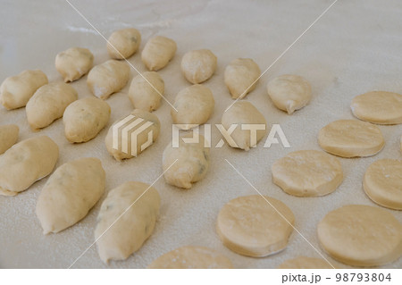 Preparation to baking bun with stuffing and donuts from yeast dough Preparation to baking bun with stuffing and donuts from yeast dough 98793804