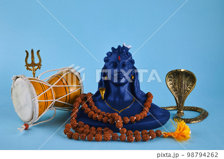 Shivaratri background with Shivas trident, Pellet Drum Damroo musical instrument ans snake . Maha Shivratri festval Shivaratri background with Shivas trident, Pellet Drum Damroo musical instrument ans snake . Maha Shivratri festval 98794262