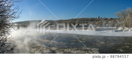 Sherbrooke Quebec Canada, winter landscape cold temperature frozen river mist and fog ice water panorama Sherbrooke Quebec Canada, winter landscape cold temperature frozen river mist and fog ice water panorama 98794557