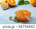 orange jam in a glass jar 98794662