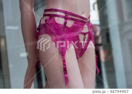 closeup of pink Suspender belt underwear on mannequin in fashion store for women 98794907
