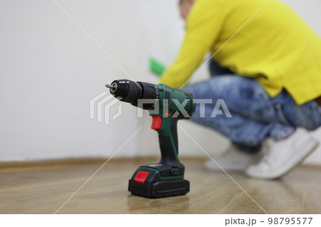An electric drill on the floor, a close-up 98795577
