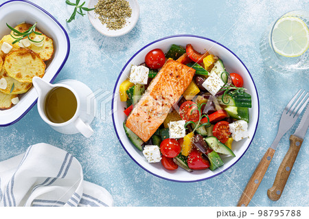 Greek salad with grilled salmon fish. Traditional mediterranean cuisine. Healthy food, diet. Top view 98795788