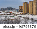 Winter urban landscape. New Residential buildings, snow covered land and privat houses 98796376