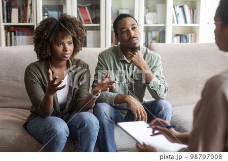 Emotional black lady complaining about her husband at therapy session 98797008