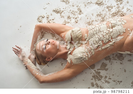 Sensual naked woman covered with dry clay 98798211