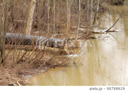 dirty water to the river on industrial from a pipe dirty water to the river on industrial from a pipe 98798629