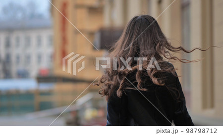 Portrait of a posing happy girl in the city in early spring. 98798712