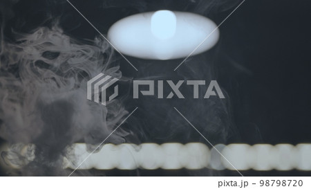 The rising smoke in the hookah bar against the background of the lamp. 98798720