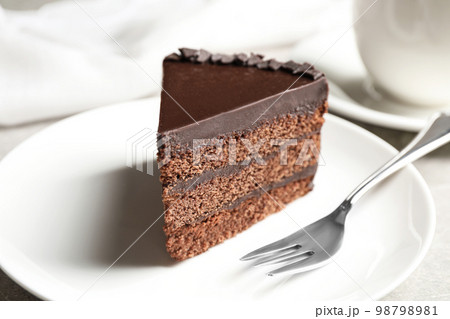 Piece of tasty chocolate cake served on plate Piece of tasty chocolate cake served on plate 98798981