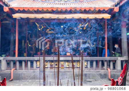 Close up shot of incense burning in the Temple Close up shot of incense burning in the Temple 98801068