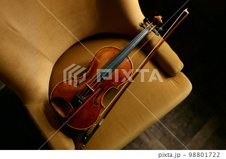 Violin musical instrument on the chair 98801722