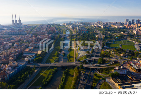 Aerial view of Besos river with Barcelona and Sant Adria on its banks Aerial view of Besos river with Barcelona and Sant Adria on its banks 98802607