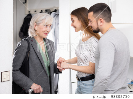 Family welcoming senior mother who came after trip 98802750