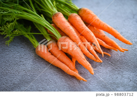 carrot on table background, Fresh and sweet carrots for cooking food fruits and vegetables for health concept, baby carrots bunch and leaf carrot on table background, Fresh and sweet carrots for cooking food fruits and vegetables for health concept, baby carrots bunch and leaf 98803712
